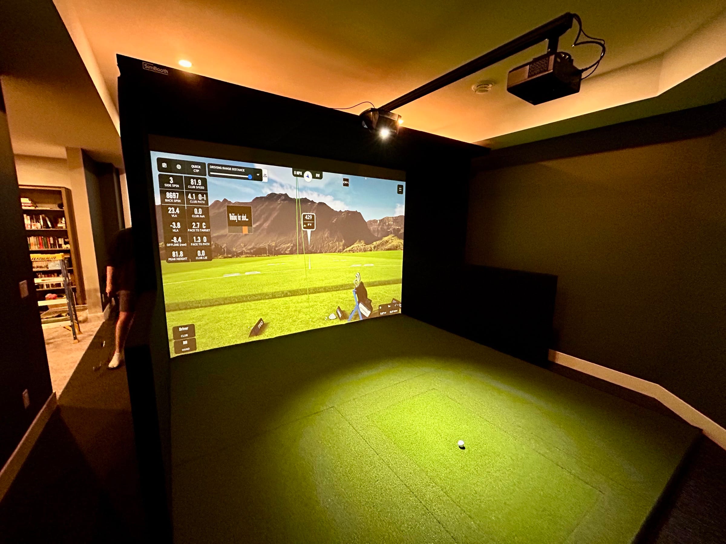 Basement simulator running a shot-analytics screen at night