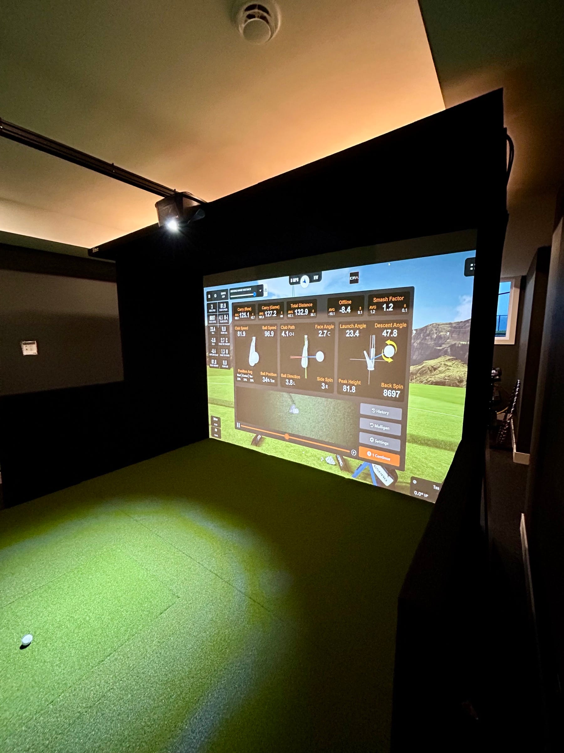 Simulator bay with live shot-analytics readout